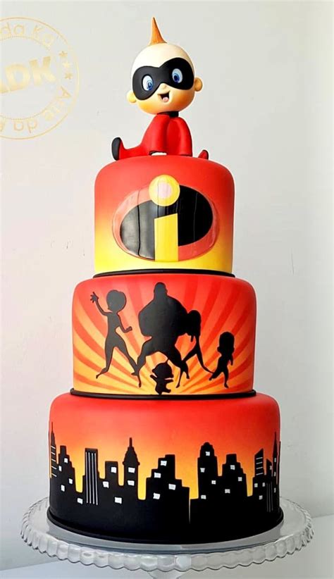 A Three Tiered Cake With Cartoon Characters On It