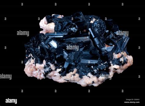 black tourmaline stone in a black isolated background Stock Photo - Alamy