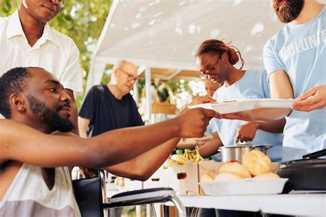 Free Photo Helpful Guy Volunteer Aids And Provides Free Food To A