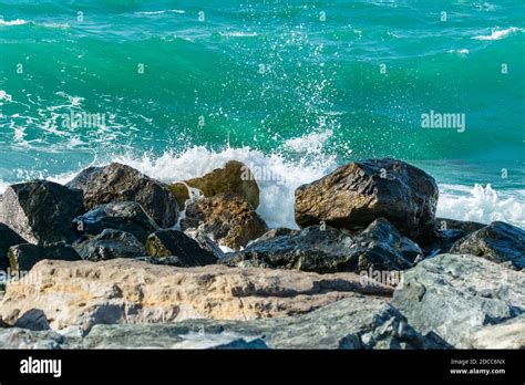 Waves Of Persian Gulf Splashing The Stones Of Breakwater At The