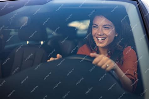 Premium Photo Happy Woman Driving A Car And Smiling Cute Young