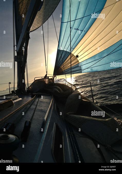 Sailboat on ocean at sunset Stock Photo - Alamy