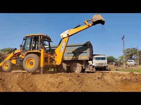 Jcb Dx Backhoe Loading Red Mud In Tata Tipper Jcb Loading Mud Truck