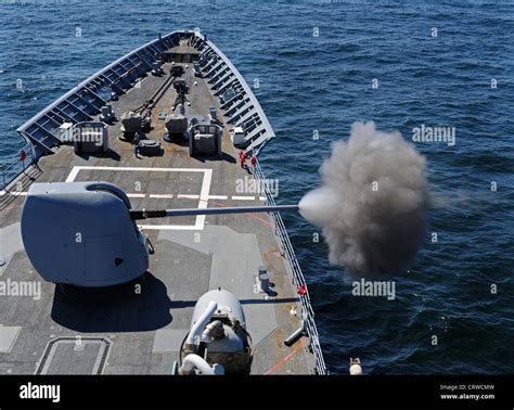 The Guided Missile Cruiser Uss Normandy Cg 60 Fires A Five Inch