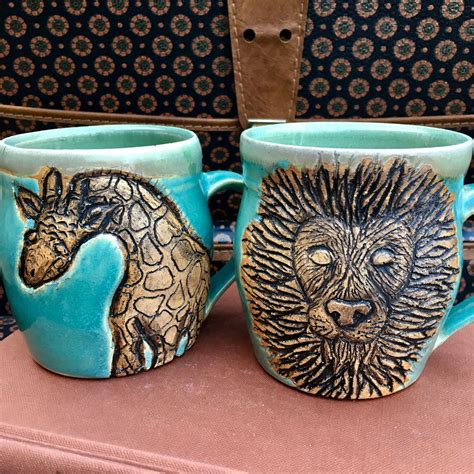 Two Coffee Mugs With Animals Painted On Them