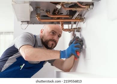 Professional Engineer Installing Natural Gas Boiler Stock Photo