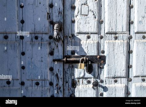 Front View Of Tthe Knocker Of An Old Blue Painted Wooden Door With