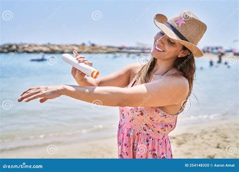 Brunette Woman Enjoying A Summer Day At The Beach Applying Sunscreen Cream Stock Photo Image