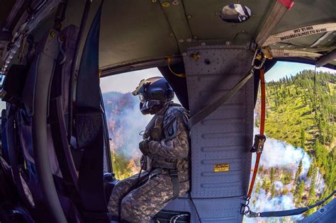 Army Sgt 1st Class Kyle Davis Communicates With H 60 Black Hawk