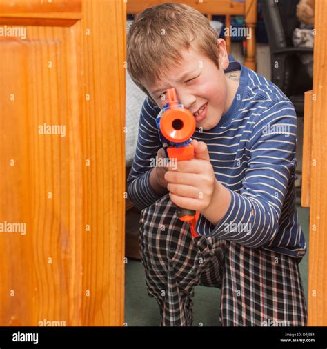 A nine year old boy with a nerf gun in his bedroom Stock Photo - Alamy