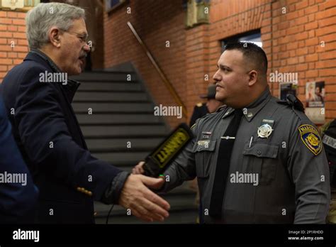 A Connecticut Judicial Marshal Uses A Handheld Metal Detector To Search