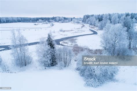 Aerial Of A Frosty And Snowy Rural Landscape With A Open River In