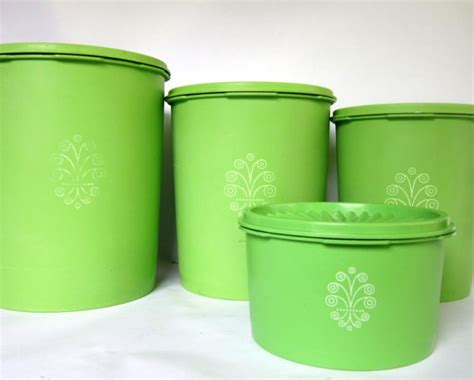 Four Green Plastic Containers Sitting Next To Each Other