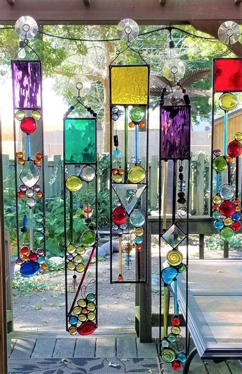 An Outdoor Area With Many Different Colored Glass Pieces Hanging From