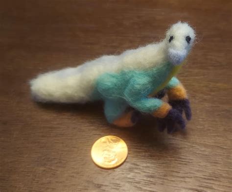 I made a scruffy needle felted therizinosaurus! Colors are loosely ...