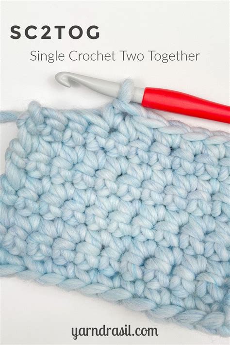 The Crochet Stitch Is Being Worked On By A Red Handled Knitting Needle