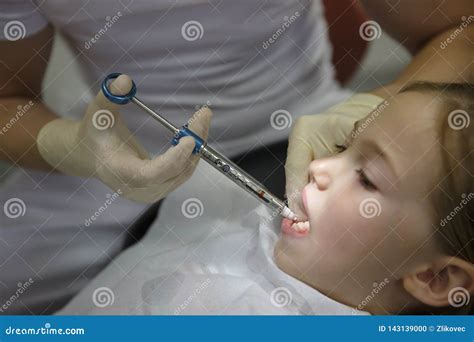 Scared Little Girl At Dentist Office Getting Local Anesthesia