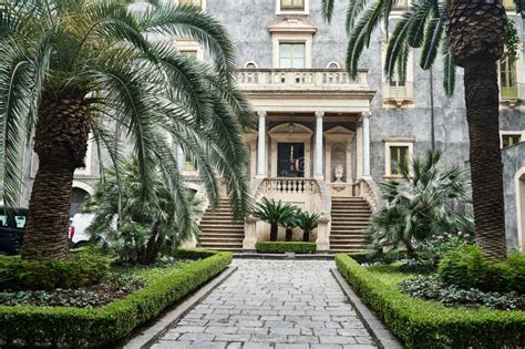 Courtyard With Palm Trees And The Entrance To A Historic Townhouse In