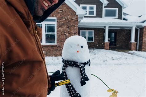 Snowman with blueberry eyes and a carrot nose. Stock Photo | Adobe Stock