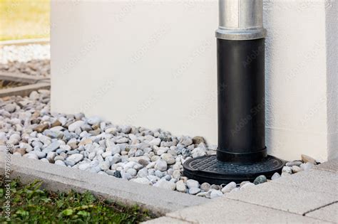 Downspout Or Downpipe Into French Drain Stones Floor Around Wall