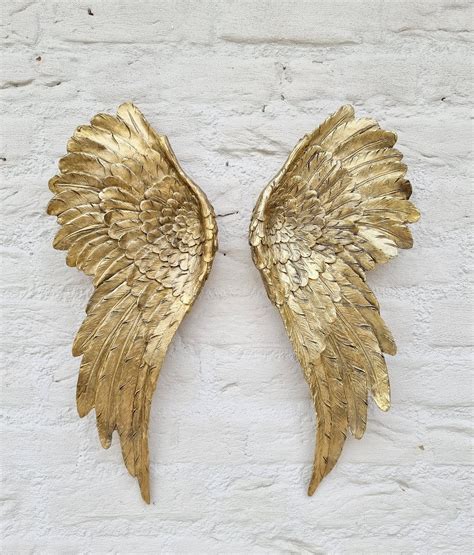 A pair of gold-colored angel wings; Christmas decoration. Wings of the ...