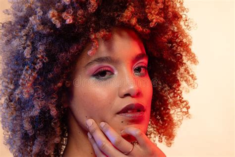 Biracial Woman With Curly Hair Wearing Pink Eyeshadow And Lipstick