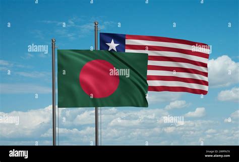 Liberia And Bangladesh Flag Waving Together In The Wind On Blue Sky