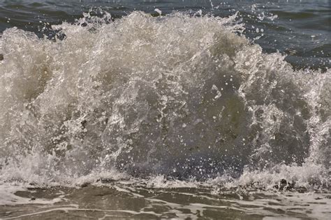 A Large Wave Crashes Into The Shore Of The Ocean Photo Free Nature