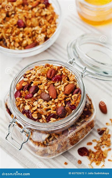 Homemade Granola In Jar On White Table Healthy Breakfast Of Oatmeal