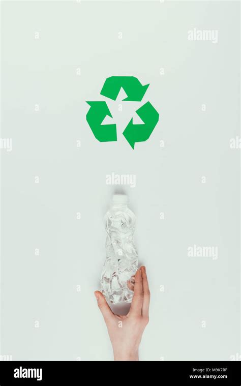 Partial View Of Woman Holding Plastic Bottle With Recycle Sign Isolated