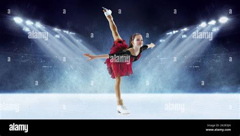 Beautiful Female Beginner Figure Skater In Stage Dress Skating At Ice Arena With Spotlights