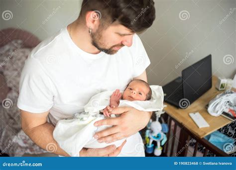 Father Holds Naked Newborn Son In His Hands In A White Diaper Stock