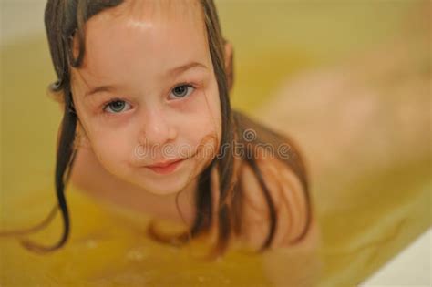 Sweet Toddler Baby Girl In Bath Child Girl Bathes In A White Bathtub