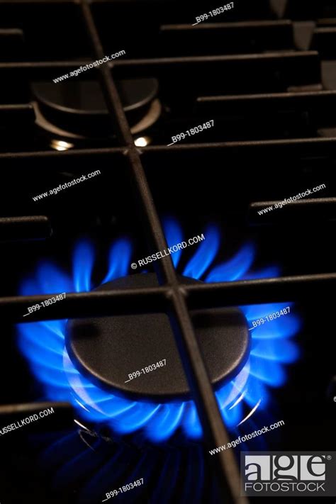 Blue Flame Of Lit Gas Burner Ring On Stove Range Top Stock Photo