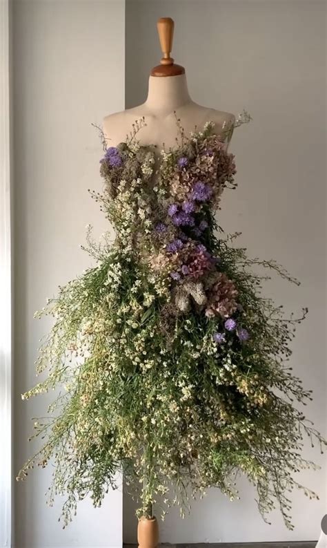 A Dress Made Out Of Flowers On A Mannequin