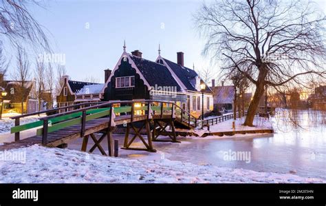 Sunrise At The Windmill Village Zaanse Schans During Winter With Snow