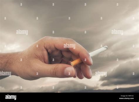 Hand Holding Cigarette While Smoking Stock Photo Alamy