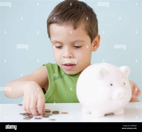 Boy Counting Coins From Piggy Bank Stock Photo Alamy