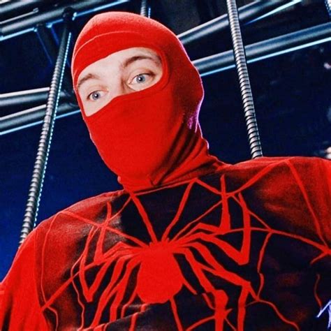 A Man Wearing A Red Spider Suit And Covering His Face