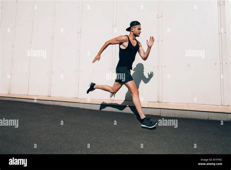 Runner Man Running Fast In Industrial City Background Sport Athletics