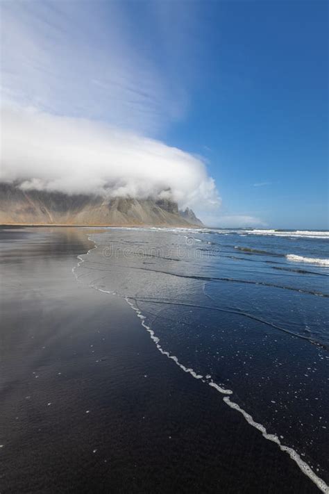 Vestrahorn Mountain With Cloud Cover In Iceland View From Black Sand