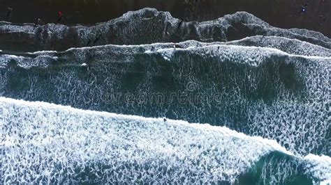 Aerial Slow Motion View Of Foamy Sea Waves Covering A Beach Stock Video