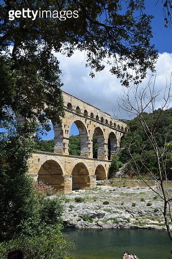 The Historic Roman Aqueduct Of Pont Du Gard That Crosses The Gardon