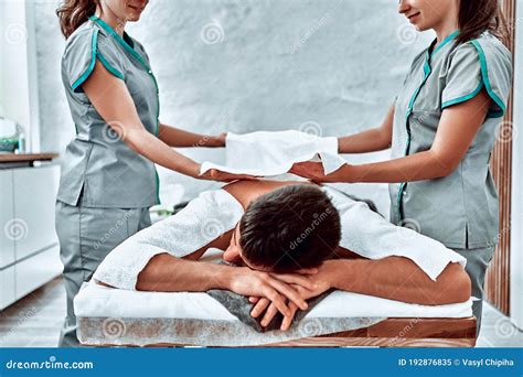 Two Women Are Massaging A Man`s Back In Beauty Center Stock Image Image Of Four Pamper 192876835