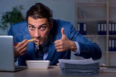 Hungry Employee Working Late In The Office Stock Image Colourbox