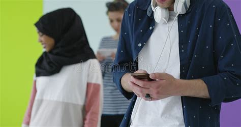 Multicultural Group Of Friends Using Cellphones Students Typing On The