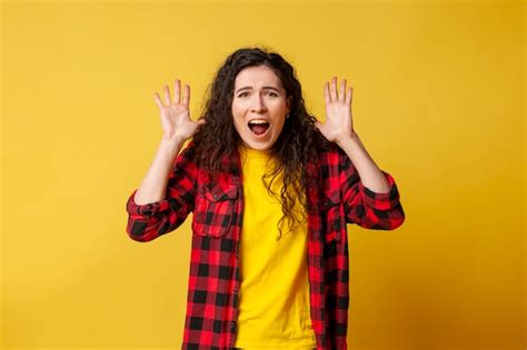 Premium Photo Curly Girl Raises Her Hands Up And Screams On A Yellow