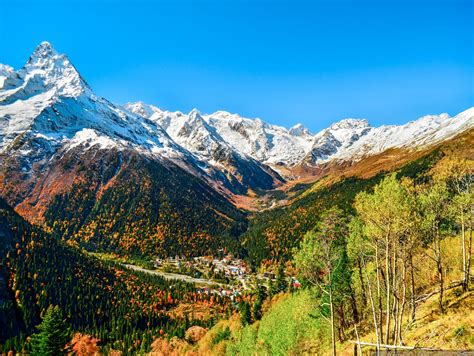 Snow Covered Mountain Peaks Of Dombay · Russia Travel Blog