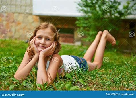 Twelve Year Old Girl Lies On The Grass And Smiling Stock Photo Image