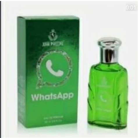 A Bottle Of Green Perfume Sitting Next To A Box With The Word Whatsapp